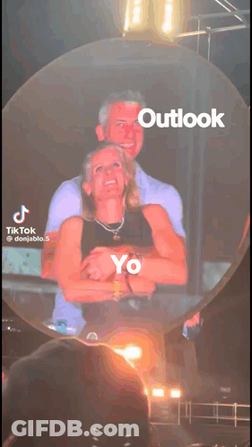 A Tiktok Video Of A Man And Woman Hugging With Outlook Written On The Bottom GIF