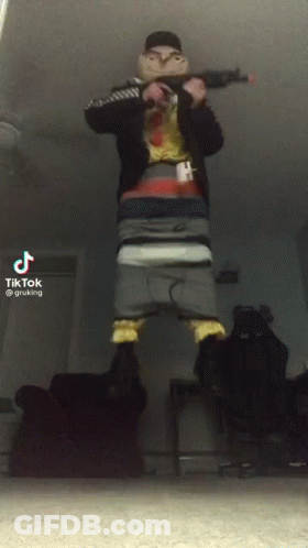 A Tiktok Video Of A Man Holding A Gun In His Hand GIF