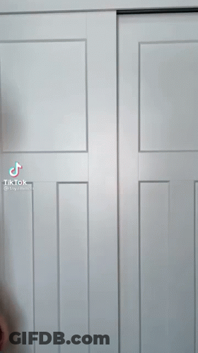 A Tiktok Video Of A Man Standing In Front Of A White Closet Door GIF