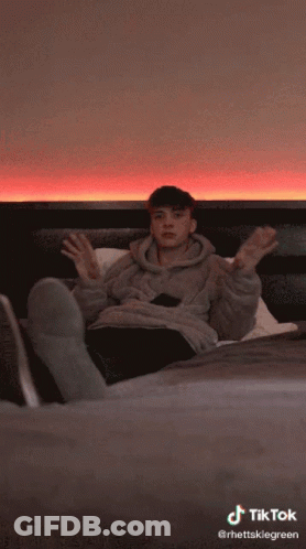 A Tiktok Video Of A Person Laying On A Bed With Their Head Down GIF
