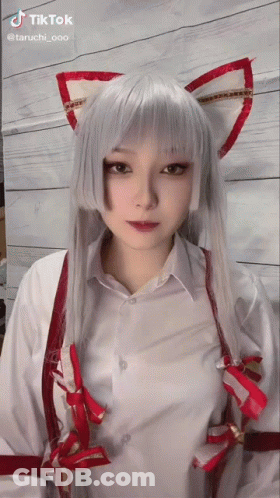 A Tiktok Video Of A Woman In A Cat Costume With White Hair And Red Ears GIF