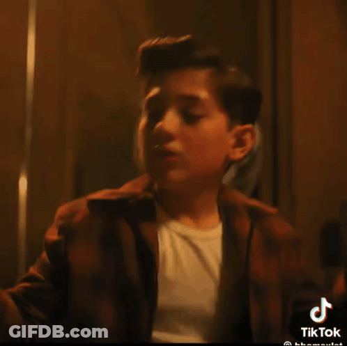 A Tiktok Video Of A Young Boy With A White Shirt GIF