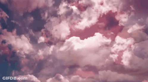 A Time Lapse Of Pink Clouds Moving In A Blue Sky GIF