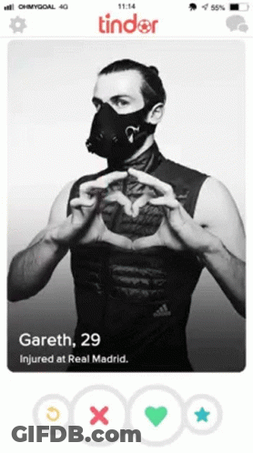 A Tinder Profile Of A Man Wearing A Mask And Making A Heart With His Hands GIF