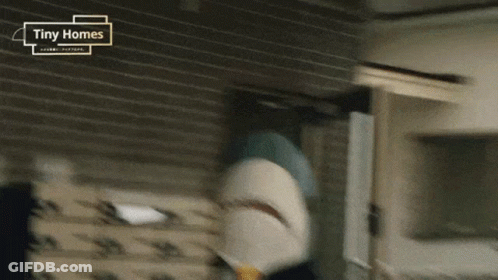 A Tiny Homes Advertisement With A Shark In The Foreground GIF