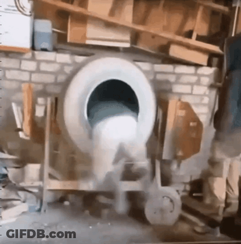 A Tire Is Being Used To Mix Concrete In A Mixer GIF