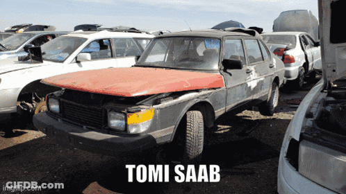 A Tomi Saab Is Sitting In A Junkyard With Other Cars GIF