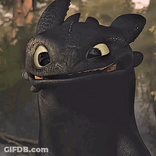 A Toothless From How To Train Your Dragon Is Smiling And Looking At The Camera GIF