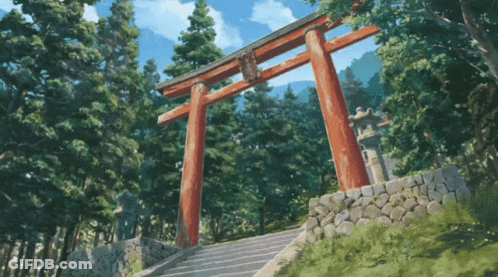 A Torii Gate In The Middle Of A Forest With Stairs Leading To It GIF