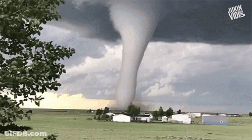 A Tornado Is Moving Through A Grassy Field With A Jukin Vine Logo In The Foreground GIF