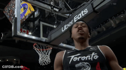 A Toronto Basketball Player Stands In Front Of A Sign That Says Uber Eats GIF