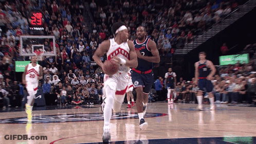 A Toronto Raptors Player Dribbles A Basketball During A Game GIF