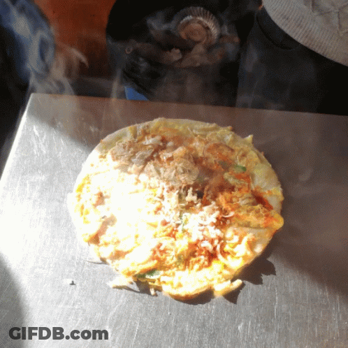 A Tortilla Is Being Cooked On A Stove Top GIF