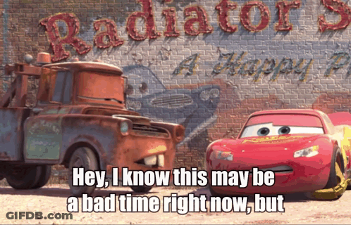 A Tow Truck And A Lightning Mcqueen Are In Front Of A Sign That Says Radiator Springs A Happy Place GIF