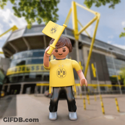 A Toy Boy Wearing A Yellow Bvb Shirt Holds A Yellow Flag GIF