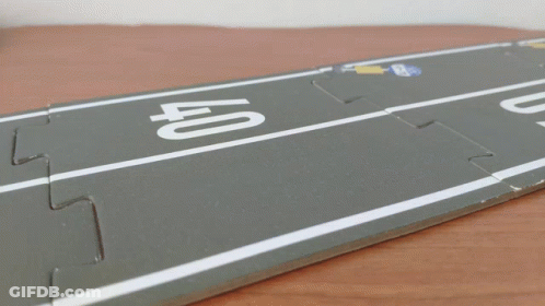 A Toy Car Is Driving On A Road With The Number 40 On It GIF