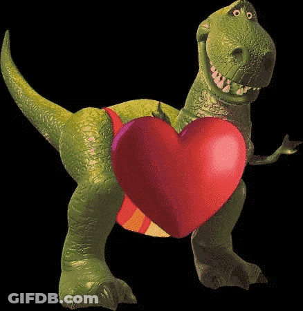 A Toy Dinosaur Holding A Green Heart On Its Back GIF