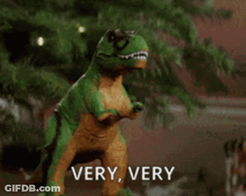Toy Dinosaur In Front Of Christmas Tree Says Very Very GIF
