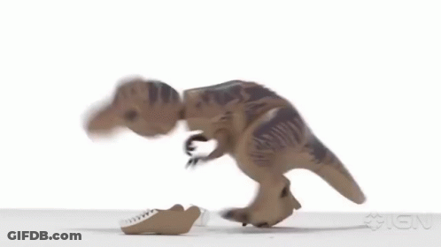 A Toy Dinosaur Is Walking On A White Surface With Its Mouth Open . GIF