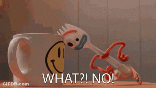 A Toy Fork Is Standing Next To A Coffee Mug With A Smiley Face On It GIF