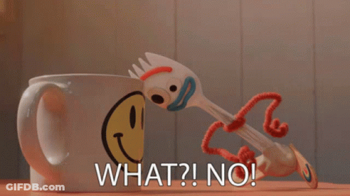 A Toy Fork Is Standing Next To A Mug That Says What ? No ! GIF