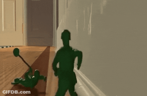 A Toy Soldier Laying On The Floor With A Hammer GIF