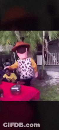 A Toy Story Character Is Standing On A Table GIF