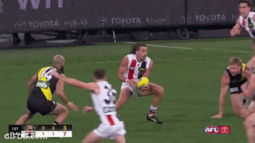 A Toyota Ad Can Be Seen Behind A Group Of Players On A Field GIF