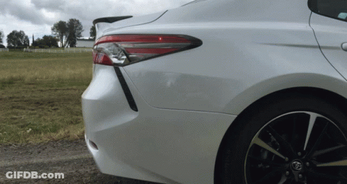 A Toyota Car Is Parked On A Dirt Road GIF