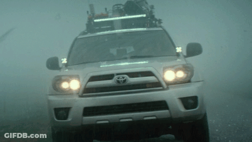 A Toyota Suv Is Driving Through The Fog GIF