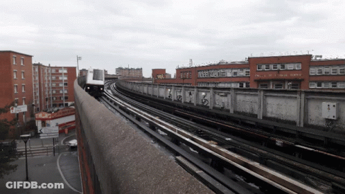Train Passing Building With Robert Sign GIF