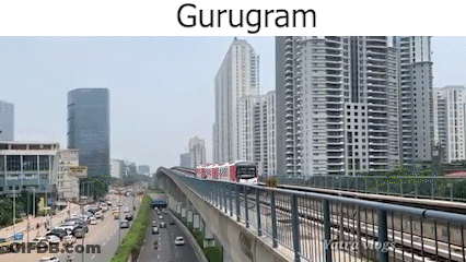 A Train Is Going Down A Bridge In A City With A Lot Of Buildings In The Background . GIF