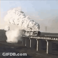 A Train Is Going Over A Bridge With Lots Of Smoke Coming Out Of It . GIF