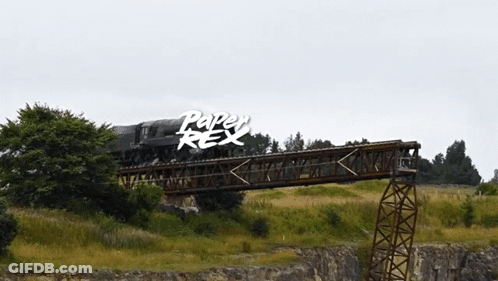A Train Is Going Over A Bridge With The Words Paper Rex Written On The Bottom GIF