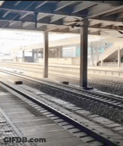 A Train Track Going Under A Bridge With A Sign That Says ' A ' On It GIF
