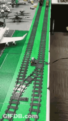 A Train Track Made Out Of Lego Is On A Table . GIF