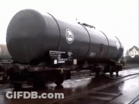 A Train With A Large Black Tank On The Side GIF