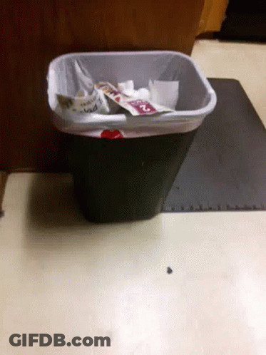 A Trash Can With A Bag That Says ' Mad ' On It Sits On A Table GIF