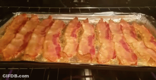 A Tray Of Bacon Is Sitting In An Oven GIF