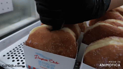 A Tray Of Doughnuts With A Label That Says Made In Animotica GIF