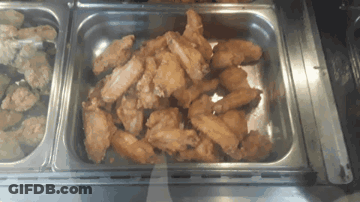 A Tray Of Fried Chicken Wings Sits On A Counter GIF