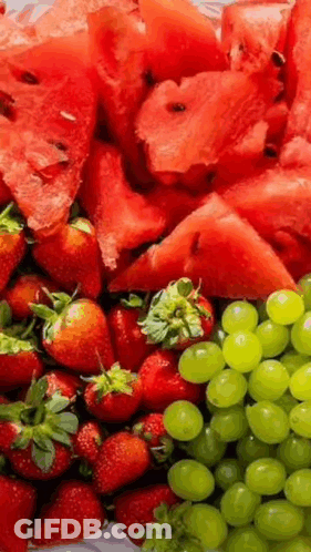 A Tray Of Watermelon , Strawberries , And Grapes . GIF