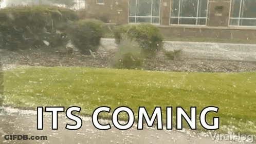 A Tree Is Being Blown Over By A Storm And The Words `` It 'S Coming '' Are Visible . GIF