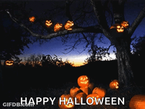 A Tree With Pumpkins Hanging From It And The Words Happy Halloween GIF