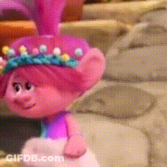 A Troll Doll With Pink Hair And A Crown Of Flowers On Her Head . GIF