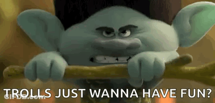 A Troll From The Movie Trolls Just Wanna Have Fun Is Holding A Stick In His Hands . GIF