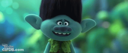 A Troll From The Trolls World Tour Is Smiling And Looking At The Camera GIF
