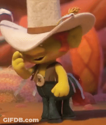 A Troll Wearing A Cowboy Hat And Pants Is Standing On A Table GIF