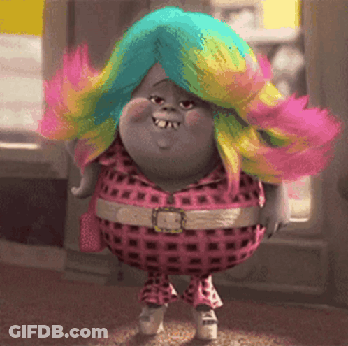 A Troll With A Rainbow Colored Wig Is Wearing A Pink Plaid Outfit GIF