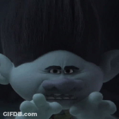 A Troll With Big Eyes And A Mustache Is Wearing A Green Vest . GIF